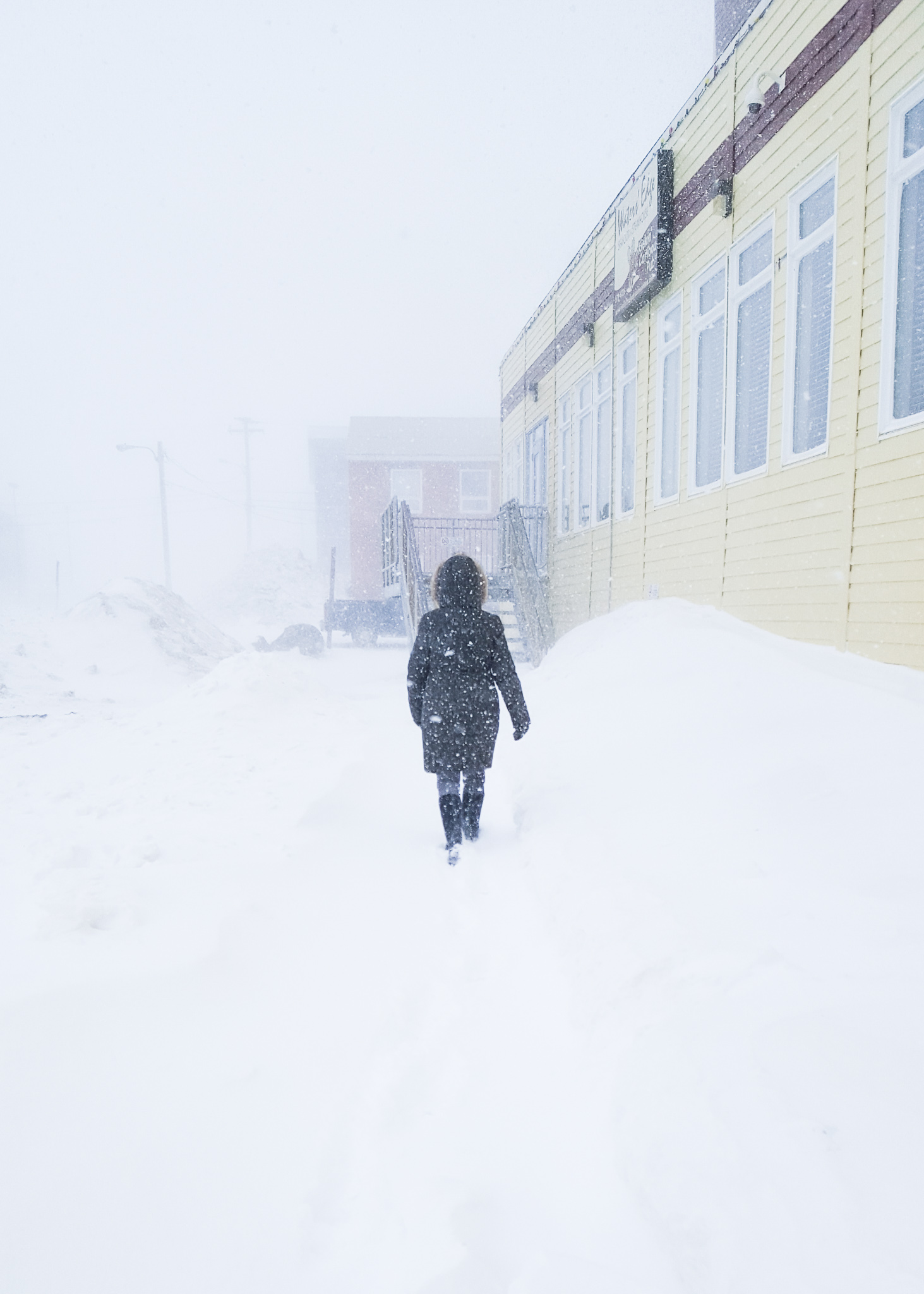 person walking through blizzard